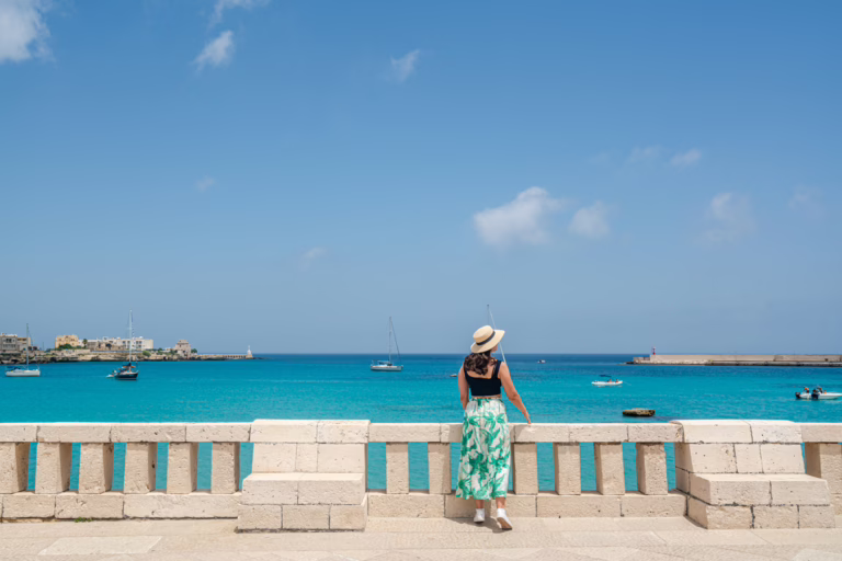 kate storm overlooking the sea on a balcony on the lungomare, one of the best things to do in otranto italy